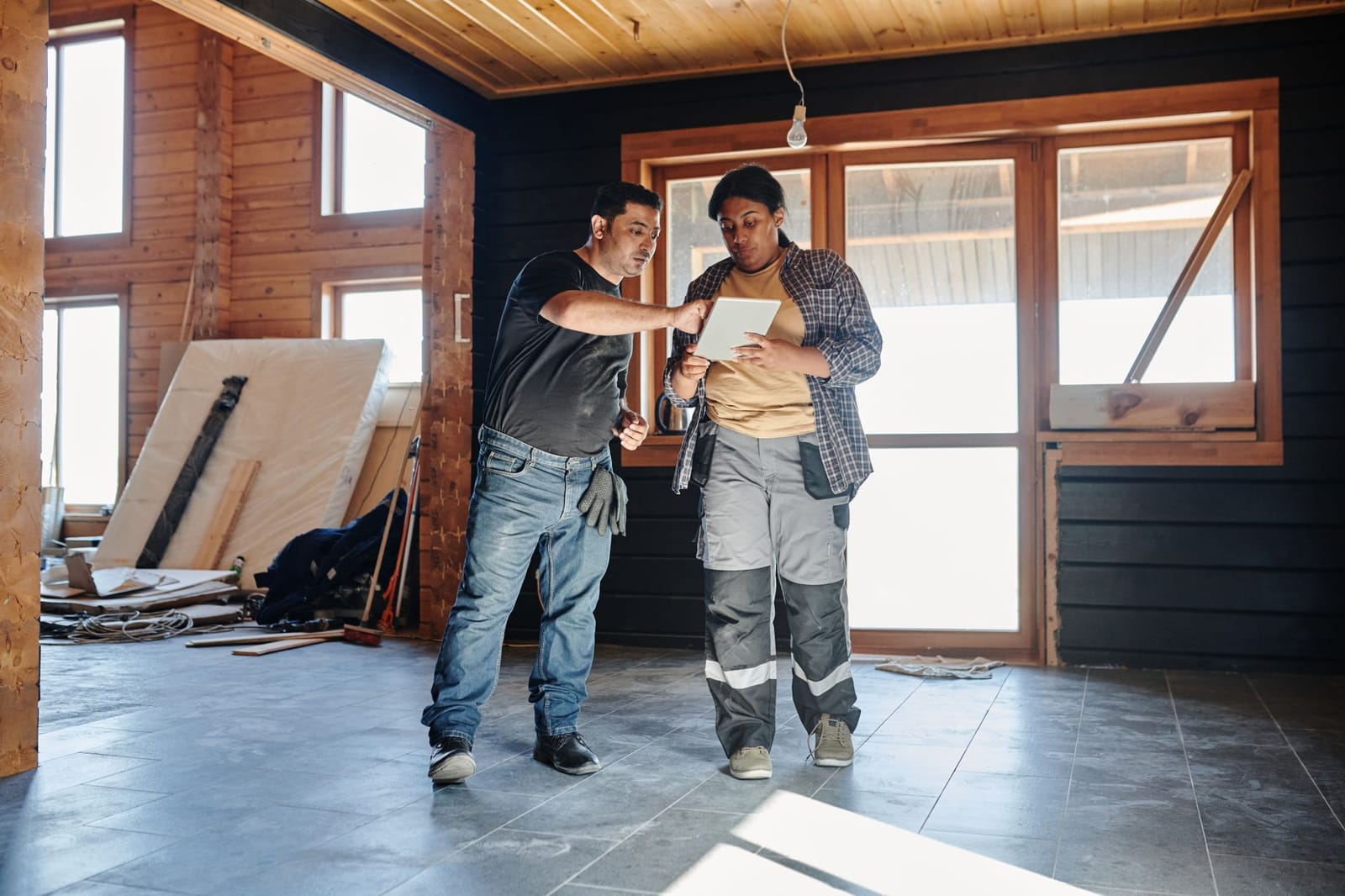 Field worker completing a digital prestart checklist on a mobile phone at a construction site